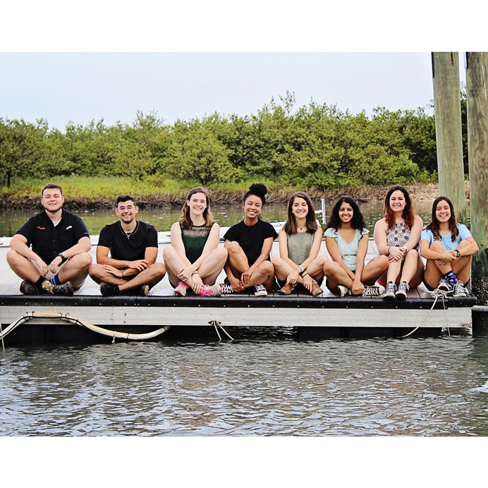 Group of students sitting on dock