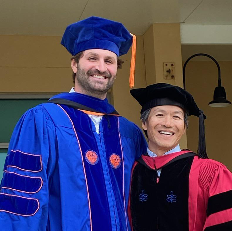 Two people in graduation attire