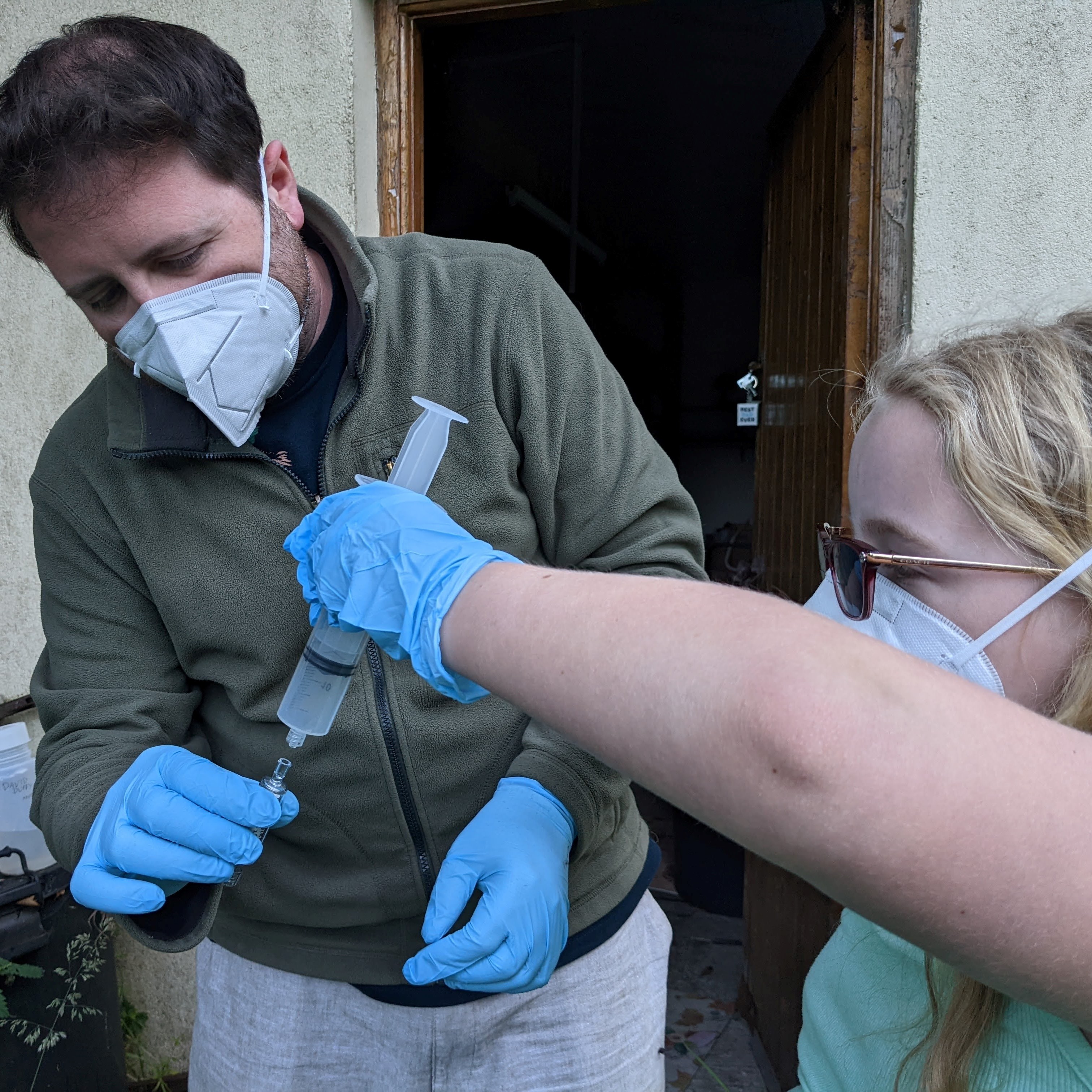 Fiona Duffy and David Duffy filtering water samples, Wicklow Ireland. DNA was found everywhere they sampled a river except the remote mountain top where the river starts. (Jenny Whilde)