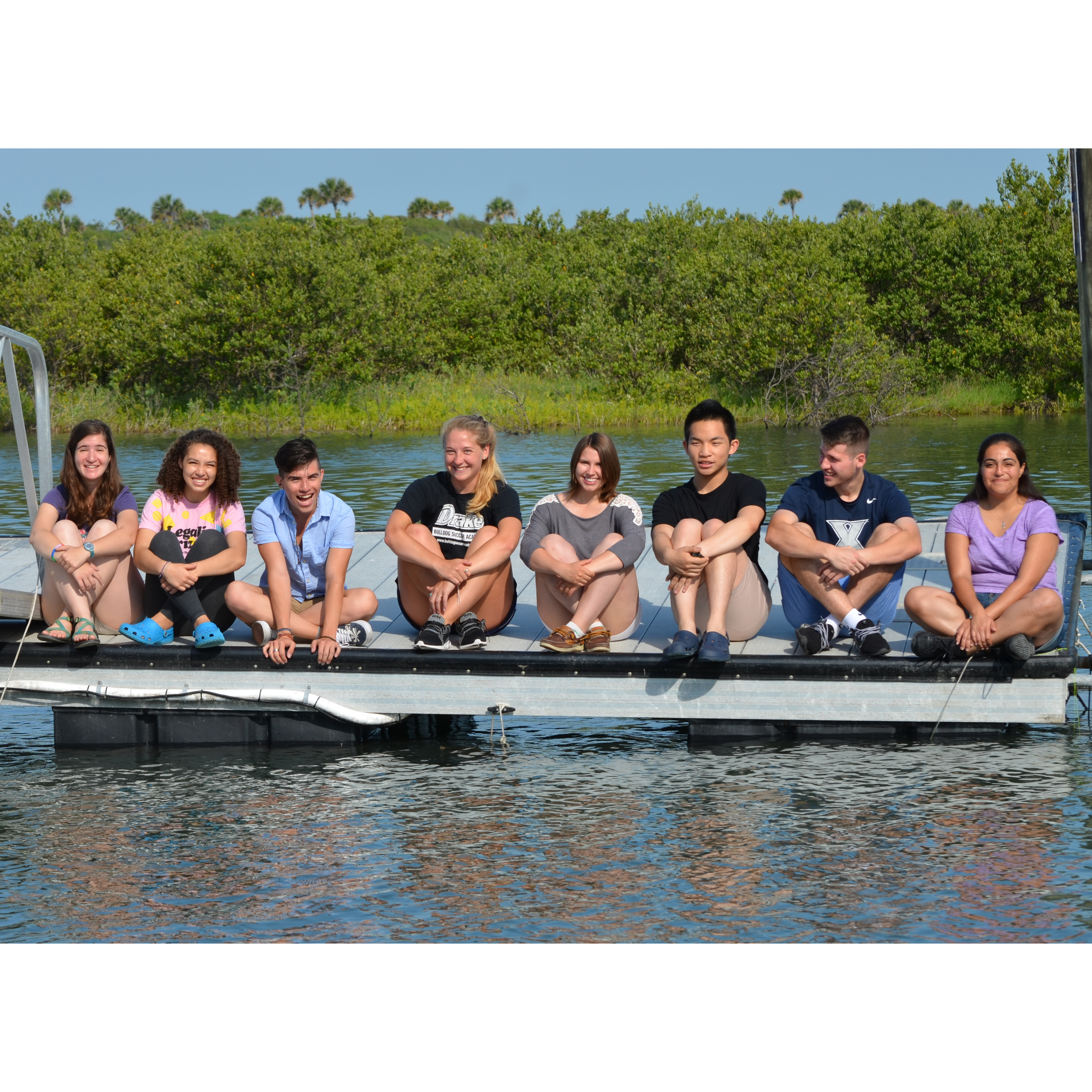 Students sitting on dock