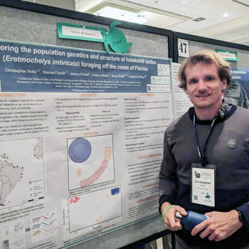 Person standing next to scientific poster