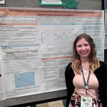 Person standing next to scientific poster