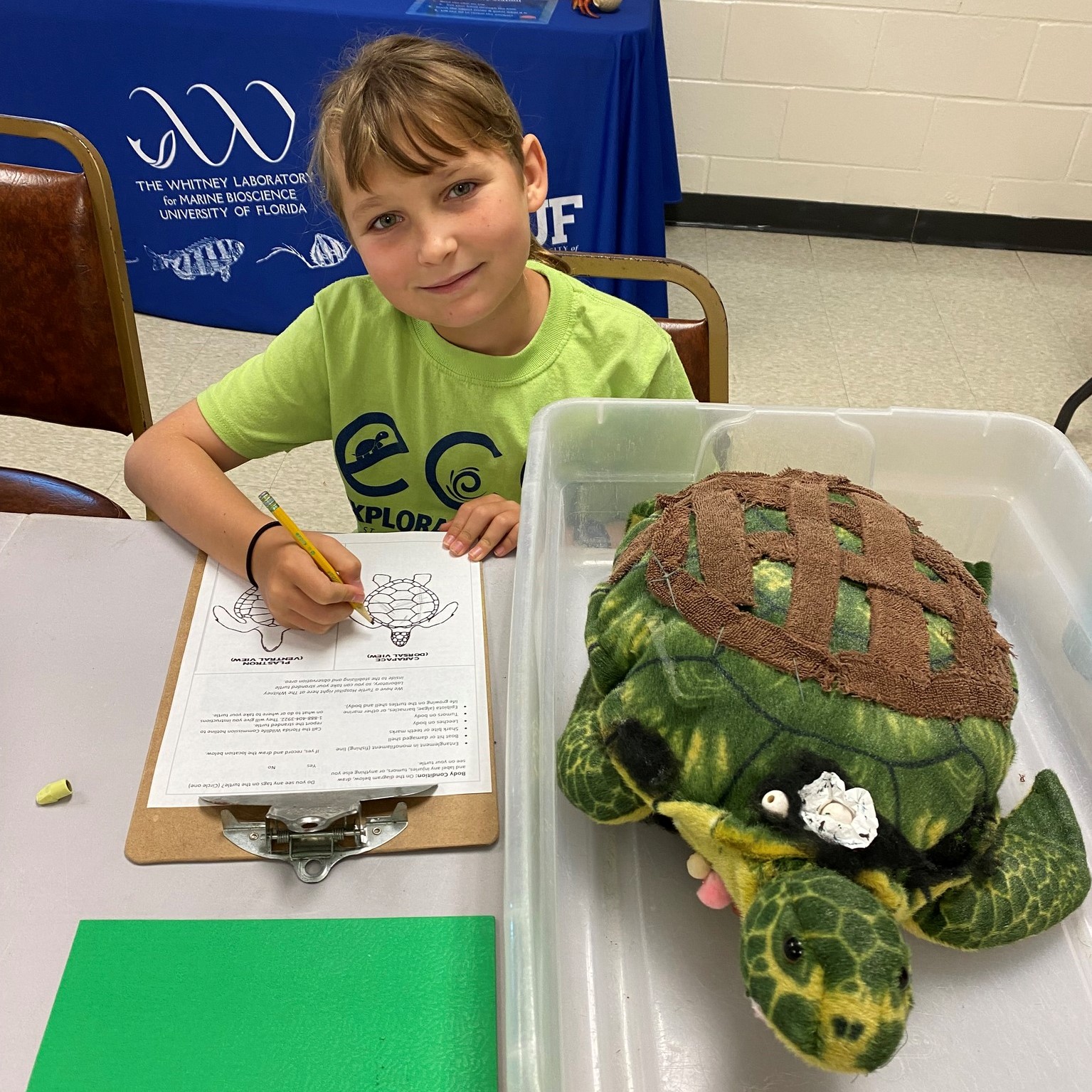 Girl with model sea turtle at camp