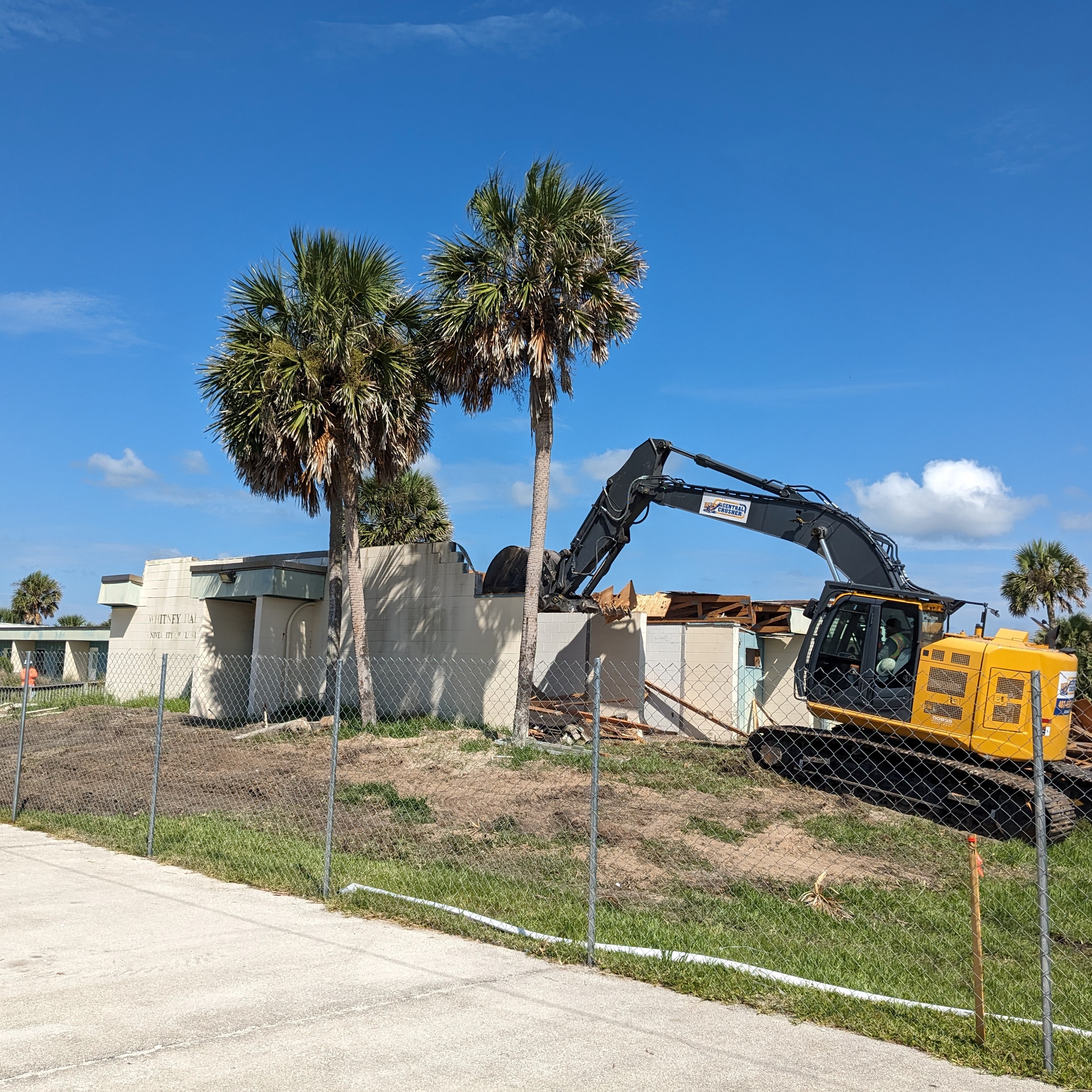 Bulldozer tearing down building