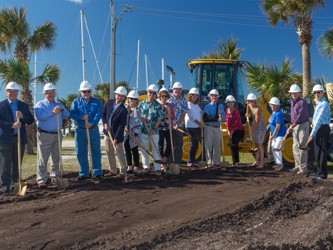 Group of people holding shovels at groundbreaking